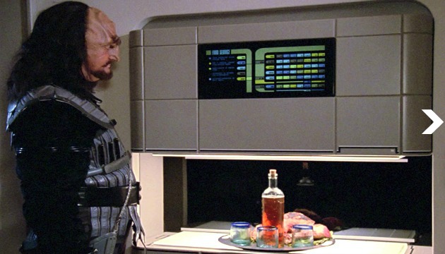 Worf gets a drink from the replicator